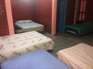 a room with two mattresses and two beds in it at Hotel Nan King in Tegucigalpa