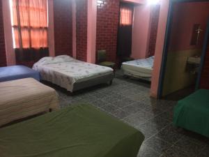 a room with two beds in a room at Hotel Nan King in Tegucigalpa