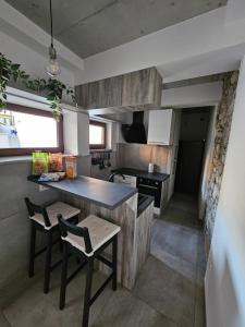 a kitchen with a table and chairs in a room at Mark & Lana in Sežana