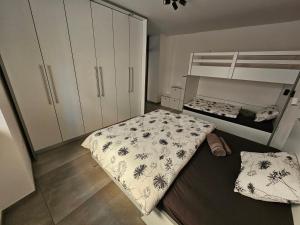 a bedroom with a bed and a bunk bed at Mark & Lana in Sežana