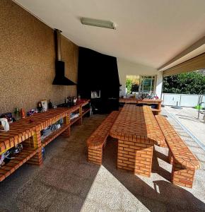 a room with long wooden benches in a building at Casa Encosta do Marao in Amarante