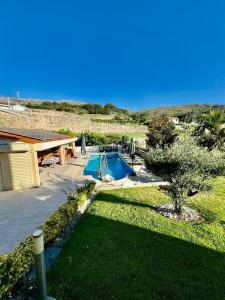 a yard with a swimming pool and a house at Casa Encosta do Marao in Amarante