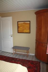 a bedroom with a bed and a bench next to a door at Bøllingsø Bed and Breakfast in Engesvang