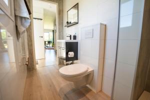 a bathroom with a white toilet in a room at Vakantiepark Lemmer in Lemmer +10 photos