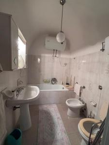 a bathroom with a sink and a toilet and a tub at Dai Nonni Vacation Home in Acciano +25 photos
