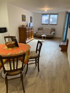 a living room with a table and chairs and a couch at Le Charme de Colmar B&B in Colmar