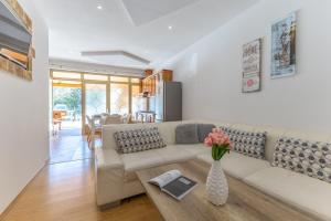 a living room with a couch and a table at Milankovic Apartments in Vrsar
