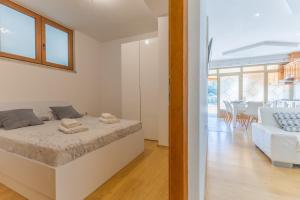a bedroom with a bed and a living room at Milankovic Apartments in Vrsar