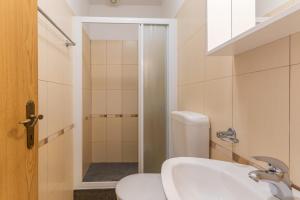 a bathroom with a toilet and a sink and a shower at Milankovic Apartments in Vrsar +31 photos