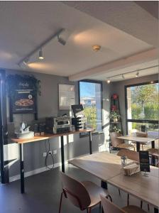 a restaurant with tables and chairs in a room at ibis budget Niort - La Crèche in La Creche