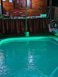 a swimming pool with a pole in the water at Pousada da Nani in São Gabriel