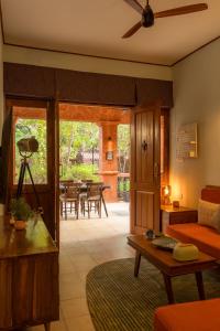 a living room with a couch and a table at Botanique Goa in Assagao