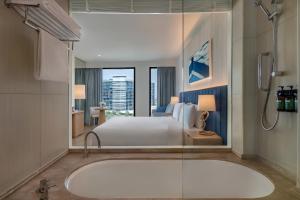 a bathroom with a bed and a bath tub at Crowne Plaza Yas Island by IHG in Abu Dhabi