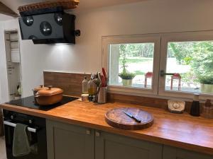 a kitchen counter with a bowl on a wooden counter top at Gîte la plotuère in Gy-en-Sologne