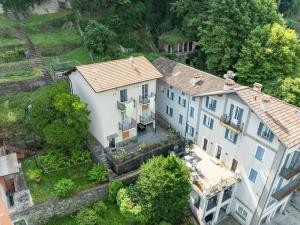 an aerial view of a large white house at Castelaus, Lake view, 1 Min Walk from the Lake in Dervio