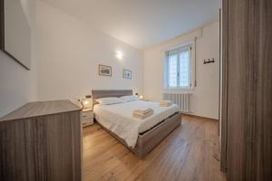 a bedroom with a bed and a desk and a window at Castelaus, Lake view, 1 Min Walk from the Lake in Dervio