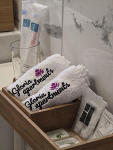 a wooden shelf with towels in a bathroom at Apartman Gloria Sajam - Senjačka pijaca in Senjak (historical) +4 photos