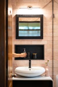 a bathroom with a white sink and a mirror at Botanique Goa in Assagao +38 photos