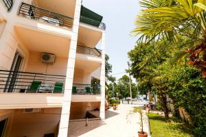 a view of a building with a palm tree at Stefanidis studios in Stavros