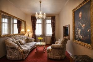 a living room with a couch and two chairs at Premier Prezident Garni Hotel and Spa in Sremski Karlovci