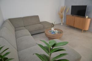 a living room with a couch and a tv at Pax et Bonum in Lozovac