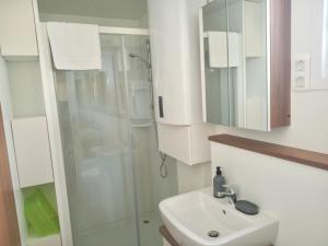 a bathroom with a sink and a shower at Hausboot Pula - Floating House Water Lily in Pula +43 photos
