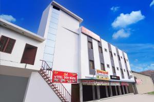 a white building with signs on the side of it at Hotel O Hotel Denmark in Chinhat +21 photos