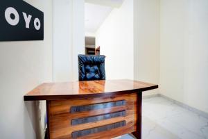 a wooden desk with a chair in a room at Hotel O Hotel Denmark in Chinhat