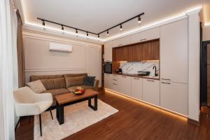 a living room with a couch and a table at Central Premium Suites in Plovdiv