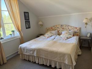a bedroom with a bed with two pillows on it at Bångbro Herrgård in Kopparberg