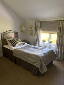 a bedroom with a large bed and a window at Bångbro Herrgård in Kopparberg +1 photo