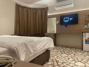 a hotel room with a bed and a flat screen tv at Dvina Hotel دفينا in Tabuk +30 photos