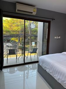 a bedroom with a bed and a view of a patio at Vera House in North Pattaya
