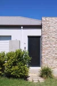 a white garage with a black door on a brick building at Sweet Home Property 7A Kewdale in Perth