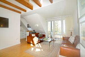 a living room with a couch and a table at Appartement Moin! in Hohwacht