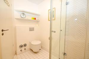 a bathroom with a toilet and a glass shower at Appartement Moin! in Hohwacht +18 photos