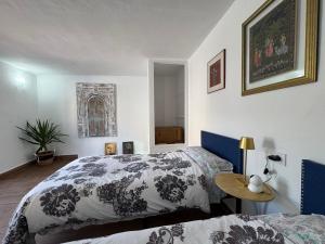 a bedroom with two beds and a table at Casa Lui Codrut in Alcalà de Xivert