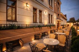 a patio with tables and chairs on a building at Premier Prezident Garni Hotel and Spa in Sremski Karlovci