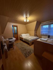 a large room with two beds and a window at Kwatery u Papieżów in Biały Dunajec +22 photos