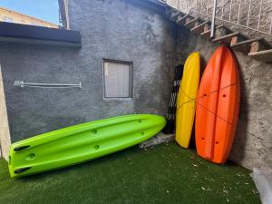 two surfboards are leaned up against a building at Immobillario - Domus Palmae in Domaso