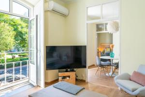 a living room with a large flat screen tv at Casa Saint Yves in Setúbal