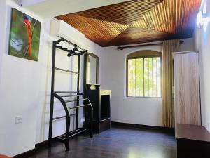 a hallway with a staircase in a room with a ceiling at Kudaarala Heritage in Kengalla