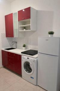 a kitchen with a washing machine and a refrigerator at Appartamento Duomo-Monte Nero in Milan