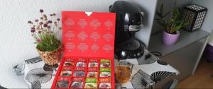 a table with a red box of donuts on it at Sleep&Coffee&Go in Trier