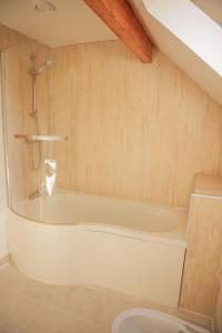 a bathroom with a bath tub in a room at Maple in Knighton +12 photos