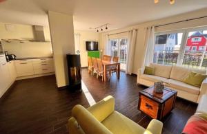 a living room with a couch and a table at Wellenläufer Breege in Breege
