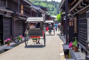 a horse drawn carriage on a city street at Takayama Fortune-inn in Takayama
