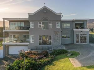 a large house with a view of the ocean at Absolute Ocean Boutique Guesthouse in Hermanus