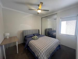 a bedroom with a bed and a ceiling fan at Sweet Home Property 7A Kewdale in Perth