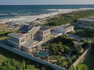an aerial view of a house next to the beach at Absolute Ocean Boutique Guesthouse in Hermanus